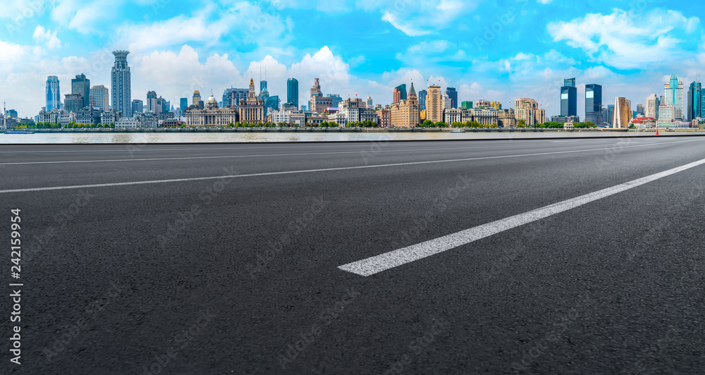 Empty asphalt road along modern commercial buildings in China,s cities Empty asphalt road along modern commercial buildings in China,s cities