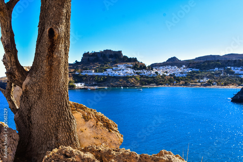 LINDOS,RHODES/GREECE OCTOBER 29 2018 : Lindos village and the endless Aegean sea photo taken from Kleovoulos Tomb hill. photo