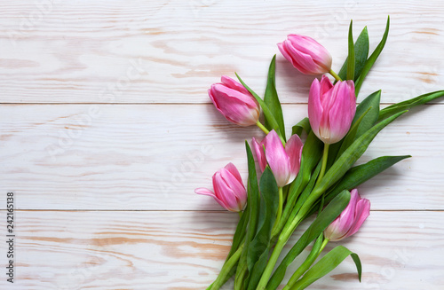 Bouquet of pink tulips. Concept for Valentine's Day, womens day and other romantic events. Top view, close-up, flat lay on white wooden background