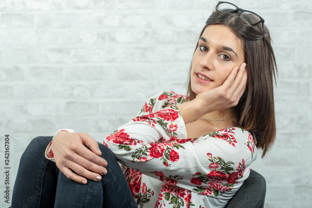 young brunette woman resting on the armchair young brunette woman resting on the armchair