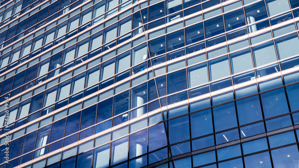 Blue Business Building. An angular and abstract full frame view of the windows to a generic contemporary office building.