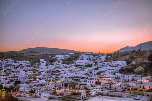 LINDOS,RHODES/GREECE OCTOBER 18 2018 : Lindos village at sunset panorama photo taken from castle