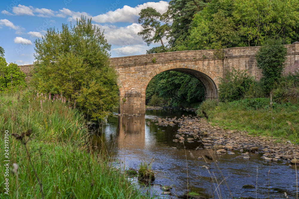 Stone bridge over the River Derwent in Blanchland, Northumberland, England, UK