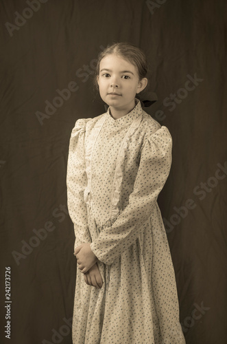 Canvas Print Little girl in early 20th century clothing in replica antique photograph
