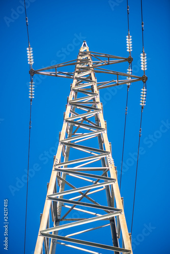Low Angle High Voltage Tower with Blue Sky Background