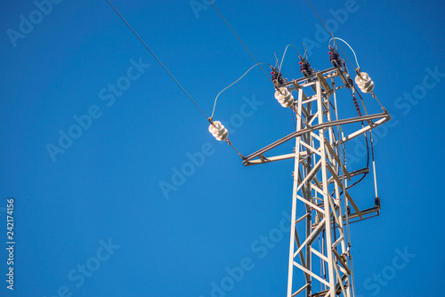 Low Angle High Voltage Tower with Blue Sky Background