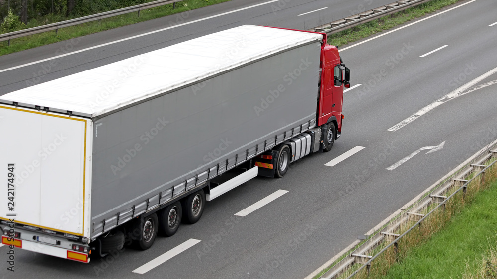 Red truck on highway in germany Red truck on highway in germany