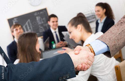 Business handshake at office meeting.