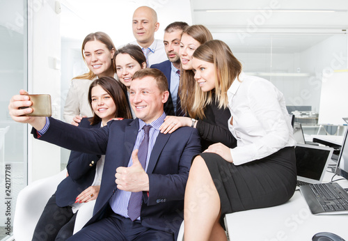 Successful business people taking selfie in coworking space