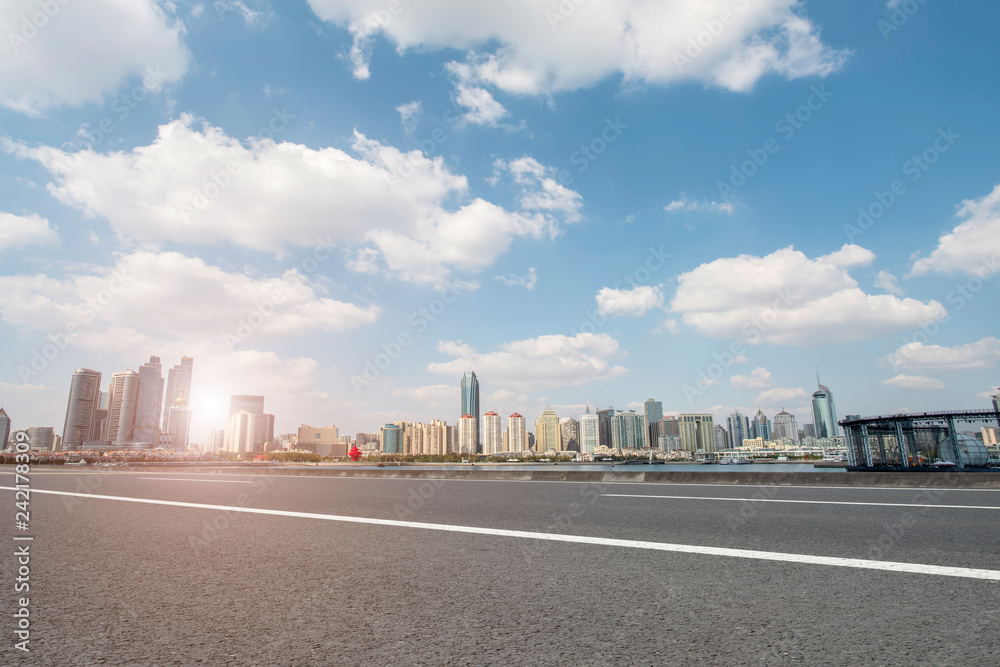 Empty asphalt road along modern commercial buildings in China,s cities Empty asphalt road along modern commercial buildings in China,s cities