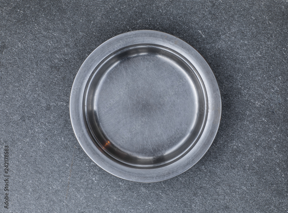 metal kitchen plate on gray concrete background,prison plate metal kitchen plate on gray concrete background,prison plate
