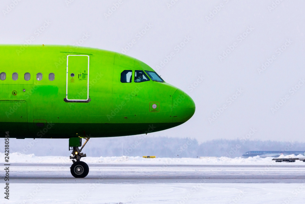Passenger plane moves in the strip in winter