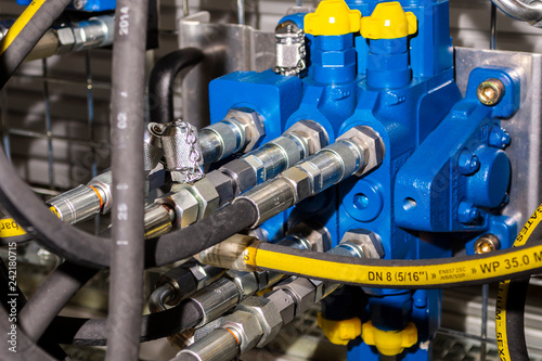 Close up of pipe system of hydraulic valves in agricultural machinery