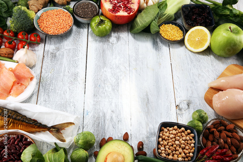 Healthy food clean eating selection. fruit, vegetable, seeds, superfood, cereals, leaf vegetable on rustic background