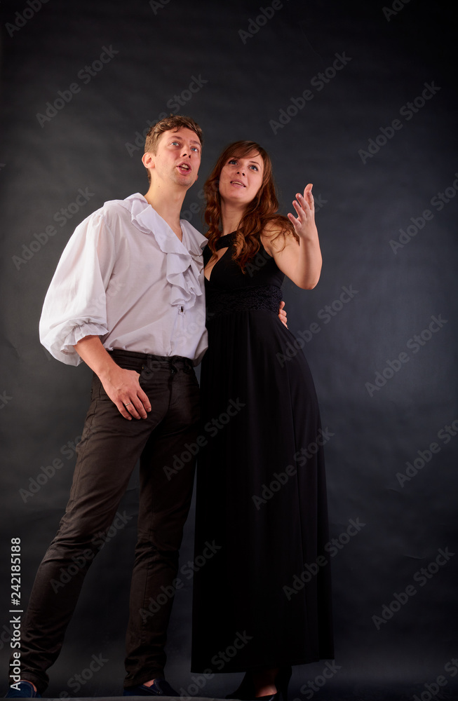 Fototapeta premium a guy and a girl stand and sing against