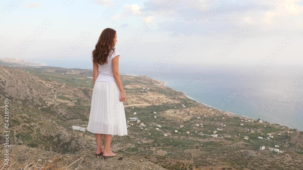 Woman on mountain top looking on sea panorama, Crete Woman on mountain top looking on sea panorama, Crete