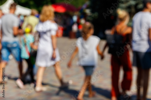 Blurred defocused abstract background of people walking on the city street. Unrecognizable faces