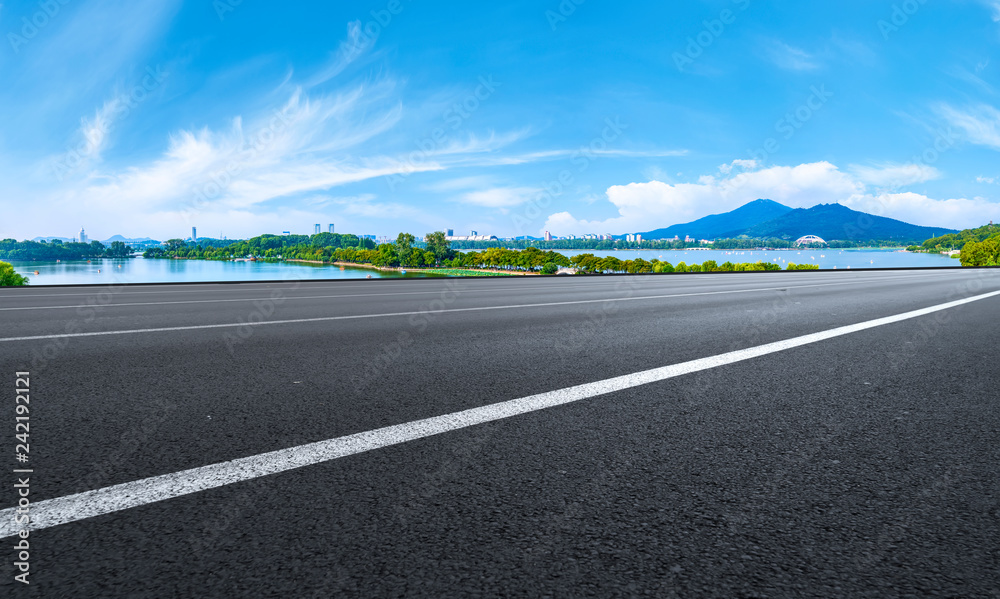 Fototapeta premium Empty asphalt road square and natural landscape under the blue sky