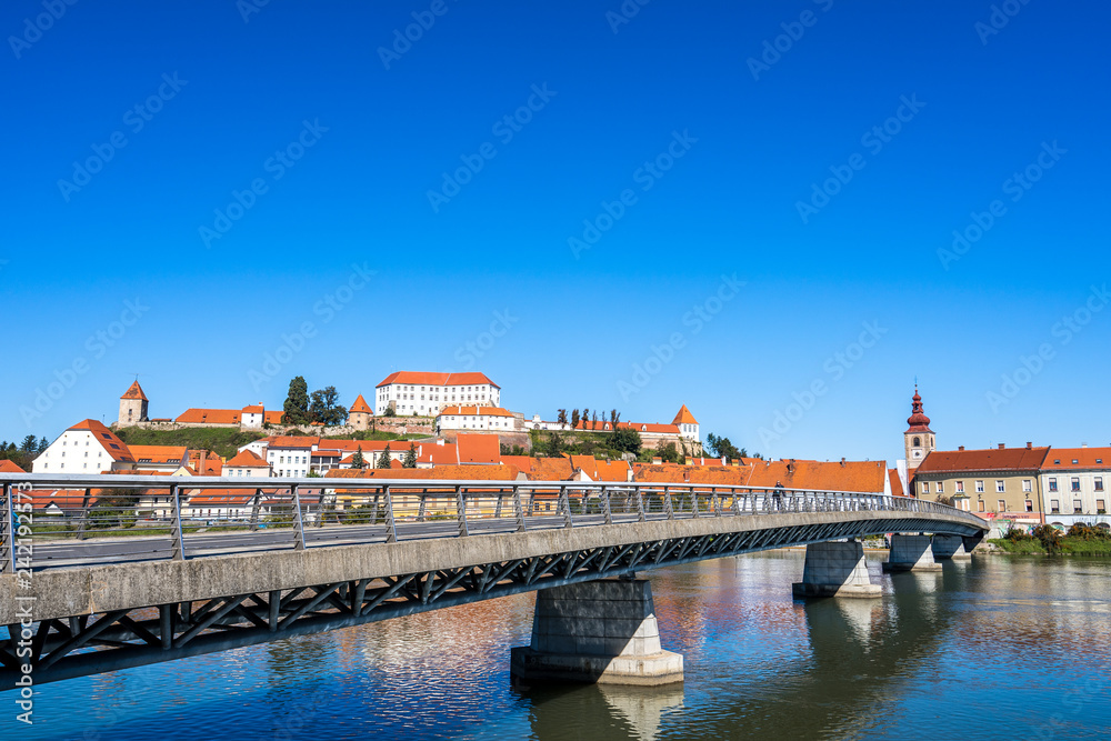 A view of the center of city of Ptuj, church, castle and old historical town of Ptuj, Slovenia. Blue sky, summer day in wine area of Ptuj, Ormoz and Jeruzalem.
