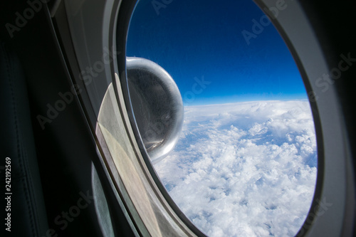 Cuadro en lienzo View from the window of the plane onto the wing and engines of a fokker 100 model with a blue sky and white clouds