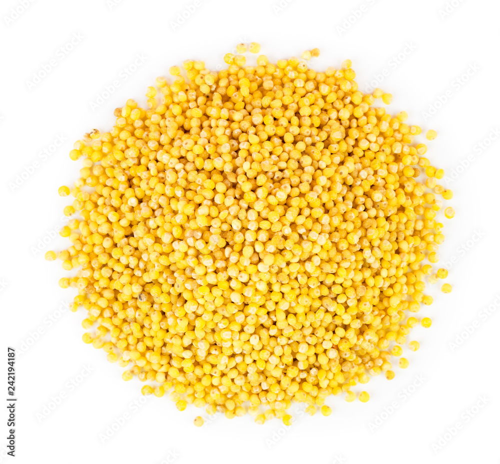 A heap of millet on a white. The form of the top. A heap of millet on a white. The form of the top.