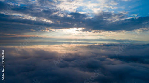 Aerial view of the heaven. Heavenly sunrise above the clouds. View from the window in the plane. Walking in the cloud.