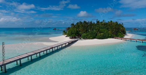Drone picture, aerial image of beautiful virgin island in Maldives with white sand and turquoise water and wooden bridge. Concept: travel magazine, honeymoon famous place © SARATSTOCK