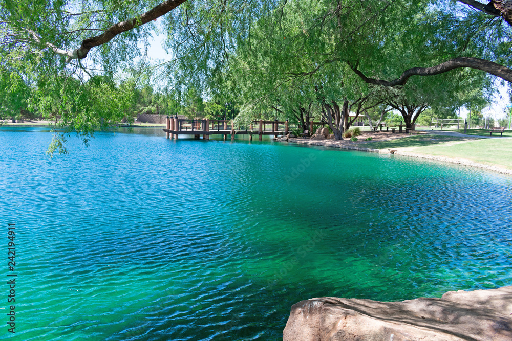 City park with lake and jetty in the background