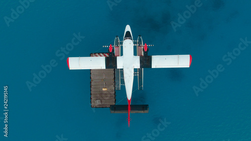 Photography Seaplane docked in the middle of the Maldivian lagoon of Indian Ocean aerial top view