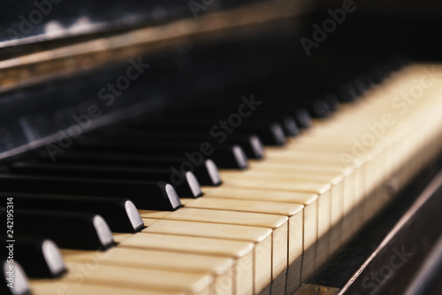 Closeup of old piano keyboard, selective focus, soft toning. Background with antique piano