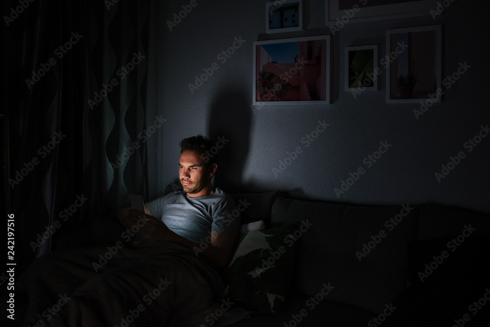 Fototapeta premium Man in pajamas with a mobile phone