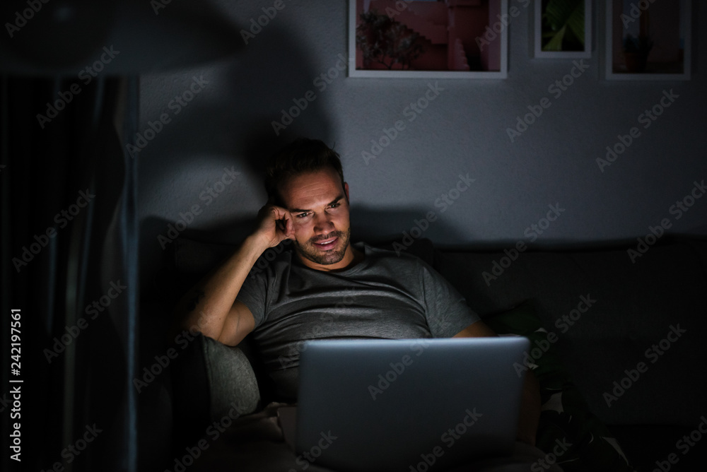 Man in pajamas with a computer
