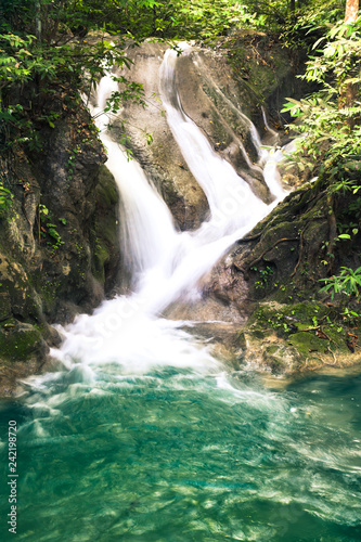 Erawan waterfall  National Park  Kanchanaburi  Thailand. Close up on water streaming from rocks into a pond.