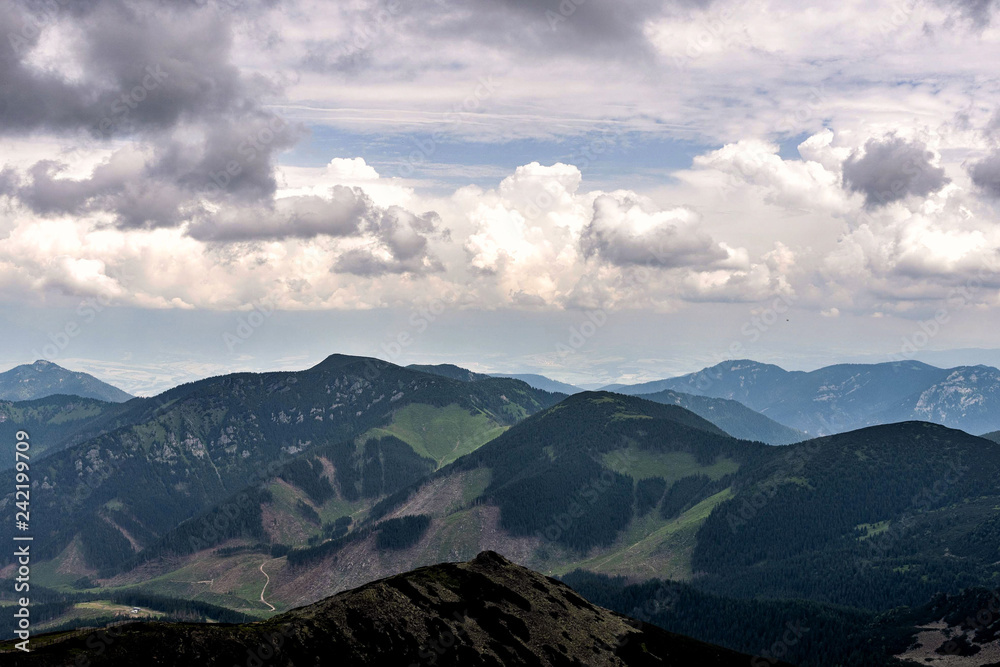 Obraz premium Summer mountains green grass and cloudy sky landscape.