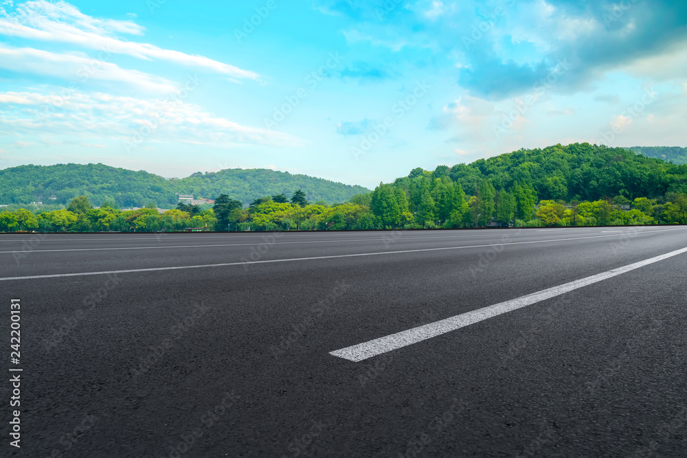 Fototapeta premium Empty asphalt road and natural landscape under the blue sky