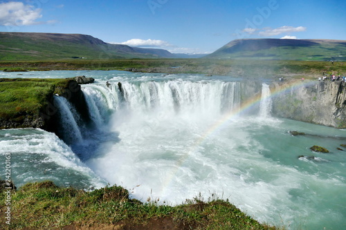 Godafoss waterfall on a glorious sunny day with rainbow, Iceland