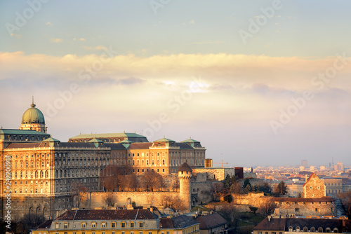 Royal Palace of Buda against Hungarian Parliament domes at sunset. Budapest, Hungary