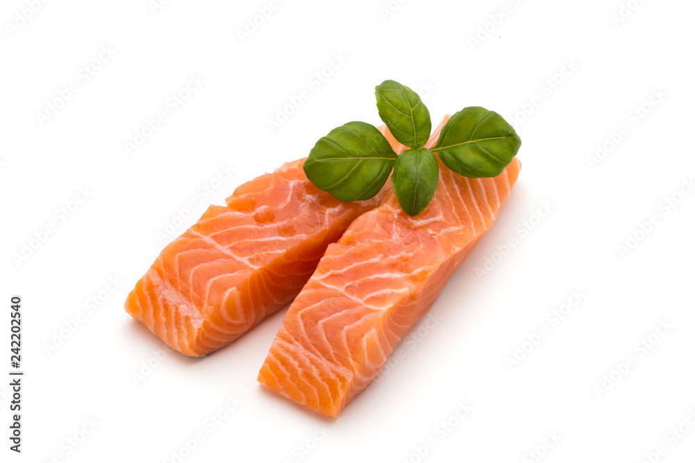 Fresh salmon fillet with basil on the white background.