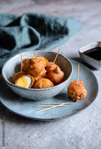 Kwek Kwek - deep fried quail eggs coated with batter served with soya sauce and vinegar dip photo