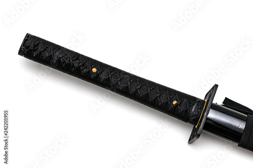 Tsuka: handle of Japanese sword  isolated in white background. Black rayskin and black cotton cord. photo