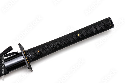 Tsuka: handle of Japanese sword isolated in white background. Black rayskin and black cotton cord.