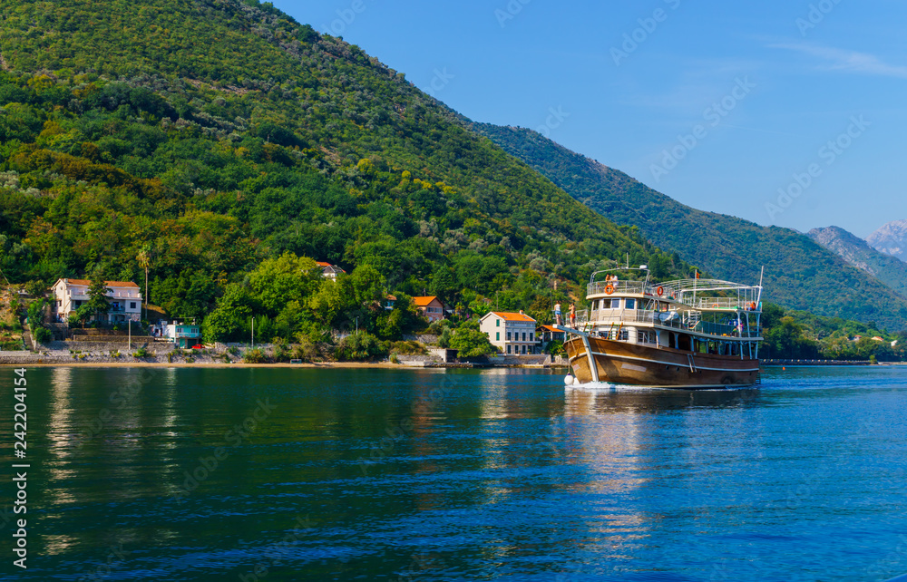 Beautiful view of the shores of Kotor Bay in Montenegro. A pleasure boat for tourists. September 22, 2018