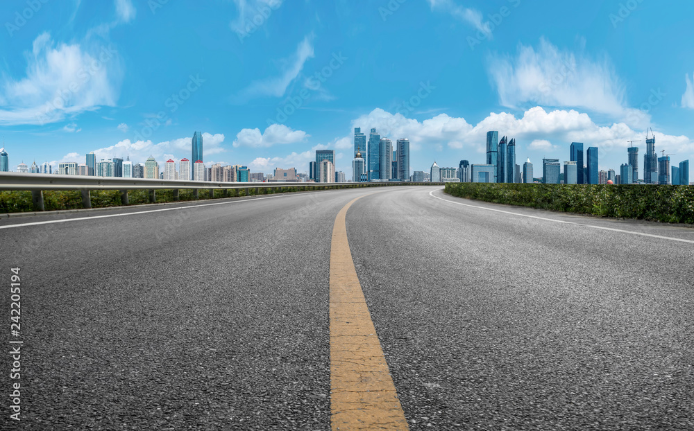 Empty asphalt road along modern commercial buildings in China,s cities Empty asphalt road along modern commercial buildings in China,s cities