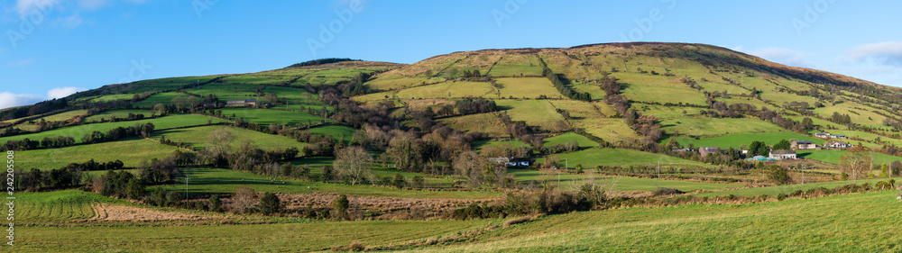 Beautiful landscape panorama of fields, farms, and hills in the Irish countryside - Glenariff, County Antrim, Northern Ireland