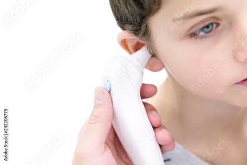 Boy having his temperature taken photo