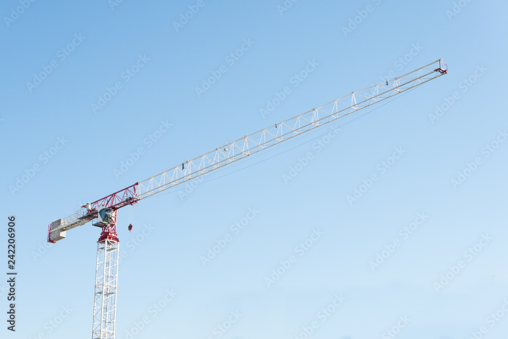 Tower crane against blue sky Tower crane against blue sky