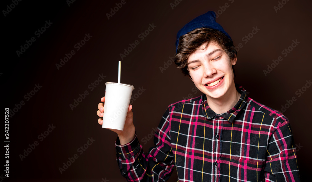 young male drink lemonade on dark background isolated f young male drink lemonade on dark background isolated f