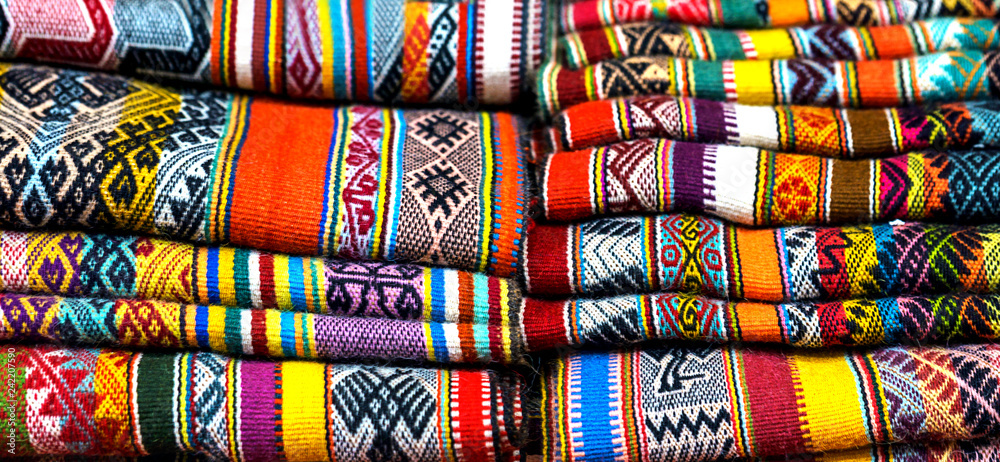 Peruvian traditional colourful native handicraft textile fabric at market in Peru, South Americain. Close up. selective focus Peruvian traditional colourful native handicraft textile fabric at market in Peru, South Americain. Close up. selective focus