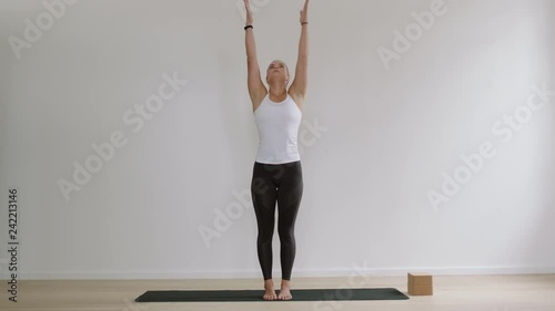 healthy yoga woman practicing mountain pose enjoying fitness lifestyle exercising in studio stretching flexible body training concentration meditation on exercise mat copy space photo