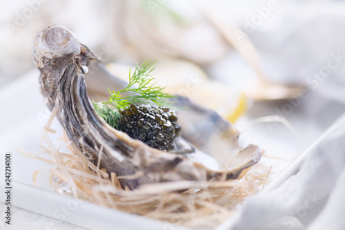 Fresh oysters with black caviar. Opened oysters with black sturgeon caviar. Gourmet food. Delicatessen